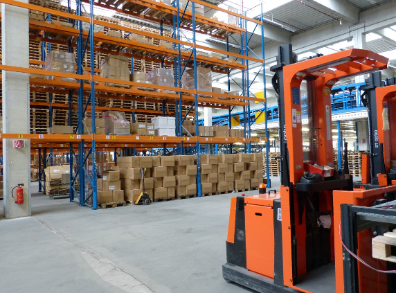 Shipping warehouse with orange forklift